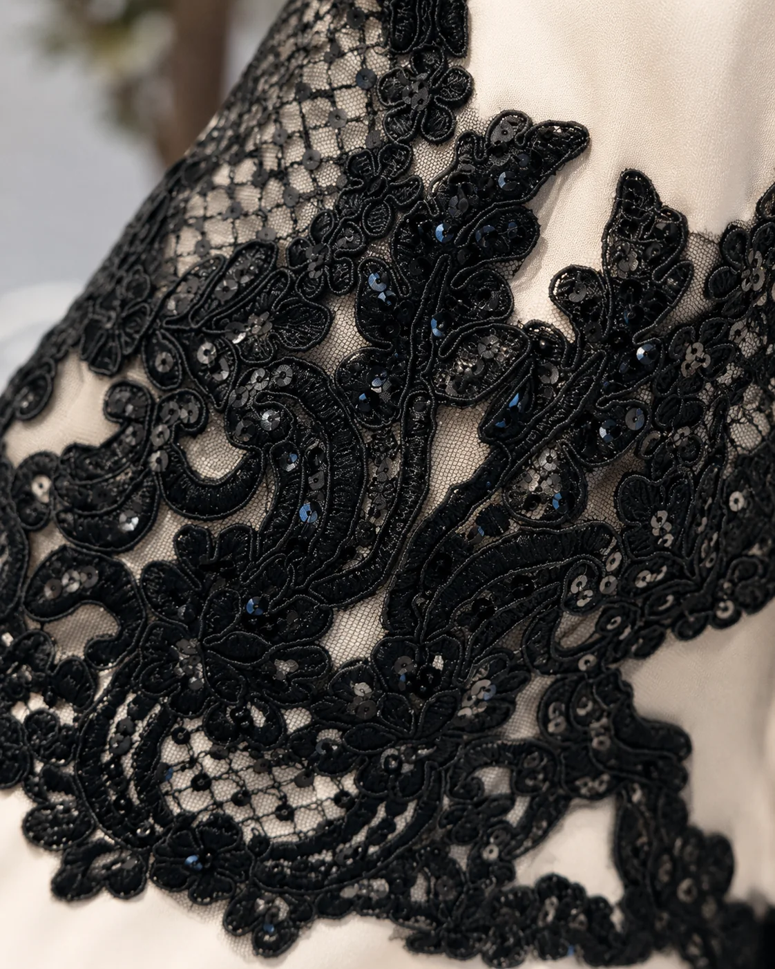 Close-up of RAYAH | راية black lace and sequin detailing